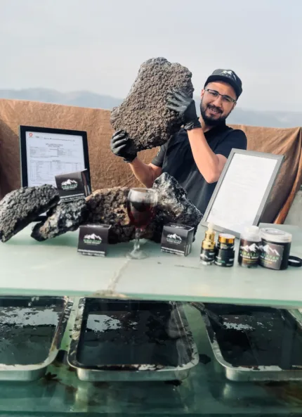 Elasna Himalayan Shilajit raw resin with team member, certification, and premium finished products display