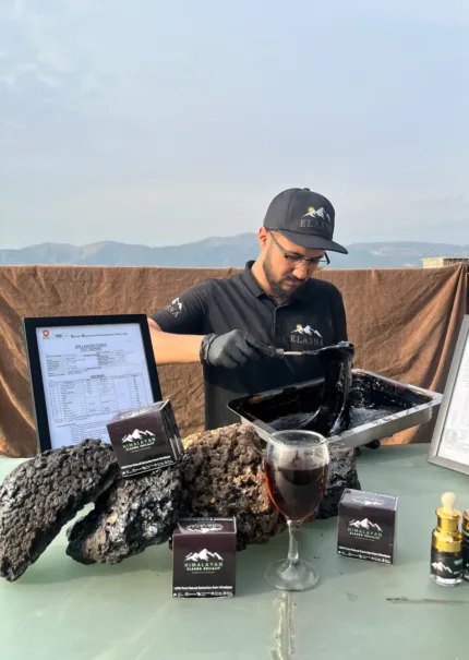 Elasna team mixing and preparing Himalayan Shilajit resin with finished products and quality display